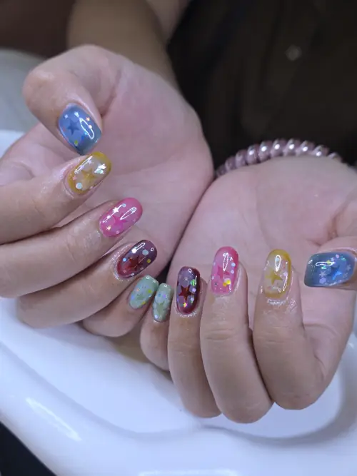 Light blue, Pink & Yellow hand-painted, glitter nails — nail design A534 at Nanny Nails, nail salon in Nakhon Phanom Thailand